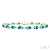 6X4 MM Oval Cut Blue Topaz and 1/6 ctw Round Cut Diamond Semi Precious Tennis Bracelet in 10K Yellow Gold